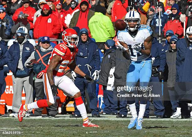 Wide receiver Tajae Sharpe of the Tennessee Titans catches a pass against pressure from defensive back Marcus Peters of the Kansas City Chiefs during...