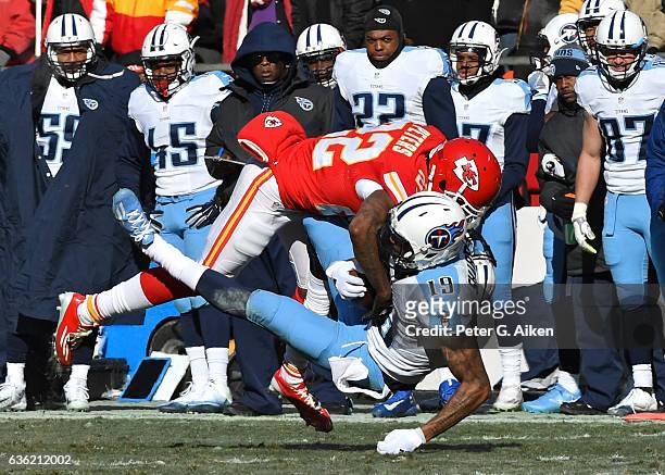 Defensive back Marcus Peters of the Kansas City Chiefs tackles wide receiver Tajae Sharpe of the Tennessee Titans during the first half on December...