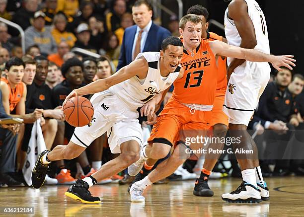 Guard Landry Shamet of the Wichita State Shockers drives against guard Phil Forte III of the Oklahoma State Cowboys during the first half on December...