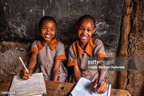 african little girls are learning english language, orphanage in kenya - africa stock pictures, royalty-free photos & images