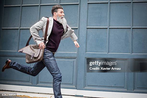 mature businessman rushing to work - street running stock pictures, royalty-free photos & images