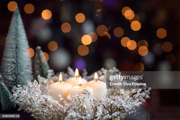 four lit candles for advent - advent stock-fotos und bilder