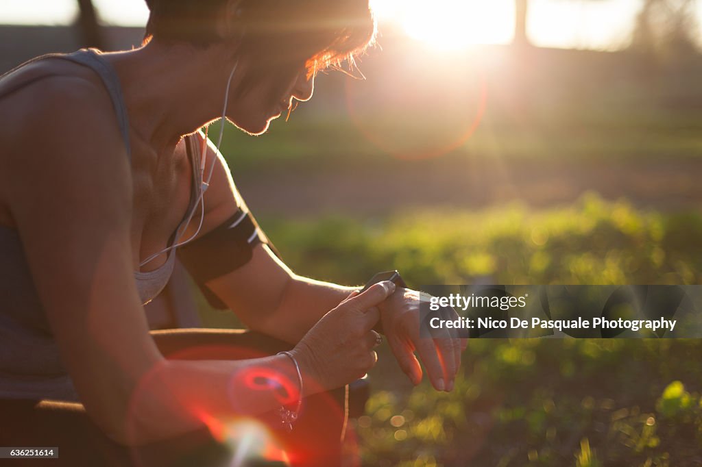 Runner in the park using smart watch