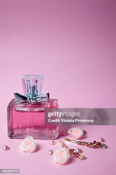 pink aromatic perfume with golden hairpins on pink - perfume atomizer stock pictures, royalty-free photos & images