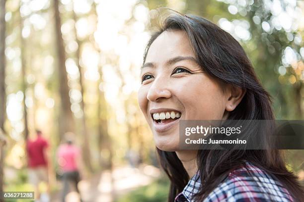 smiling asian woman looking away - mongolian women 個照片及圖片檔