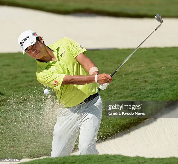 United States - Japanese golfer Hideki Matsuyama makes a bunker shot on the No. 18 hole during his practice round for the WGC Cadillac Championship...