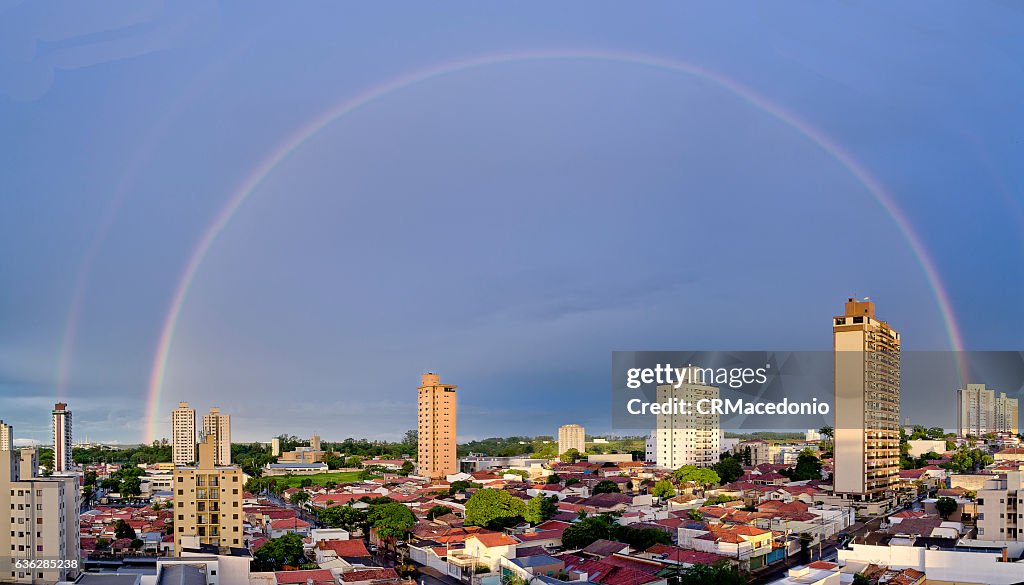 An big rainbow over city.