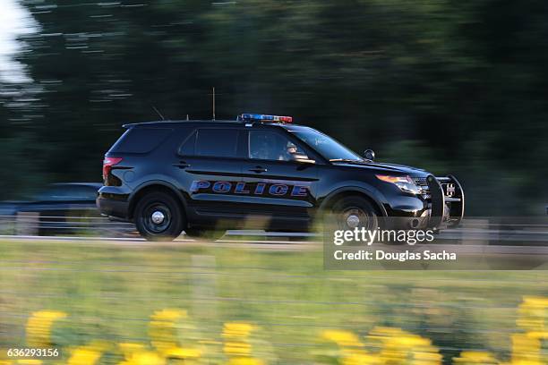 police suv on a rural highway - highway patrol stockfoto's en -beelden