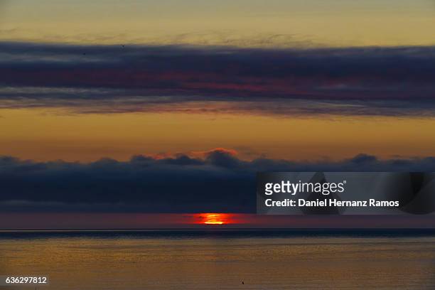 big red sun at sunset in the sea. galicia. spain - guarda sol stock pictures, royalty-free photos & images