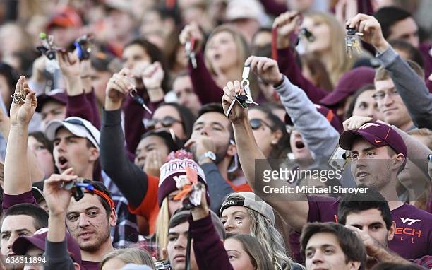 Fans of the Virginia Tech Hokies shake their keys during a third down "Key Play" in the first half against the Georgia Tech Yellow Jackets at Lane...