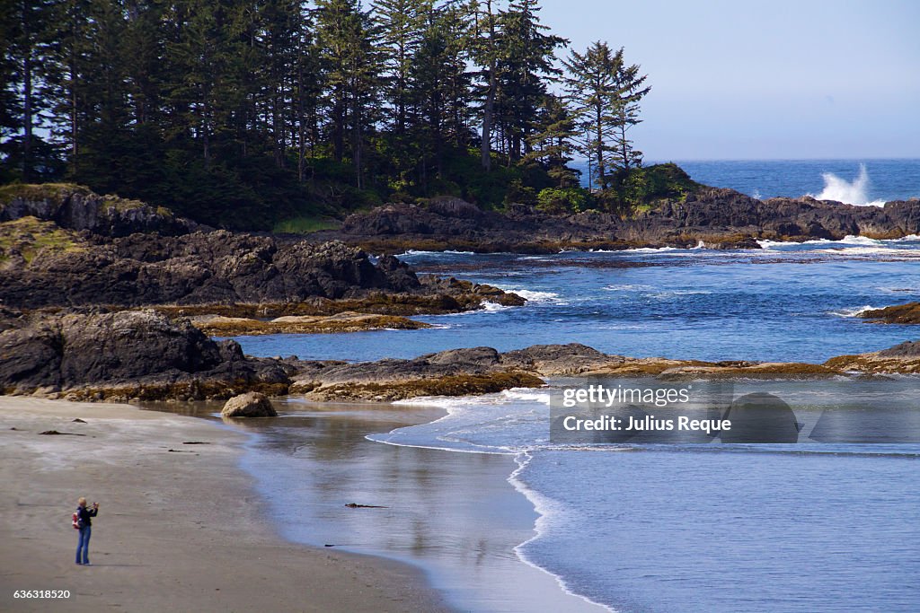 Female Person Captures a Photo of the Wave Splashing