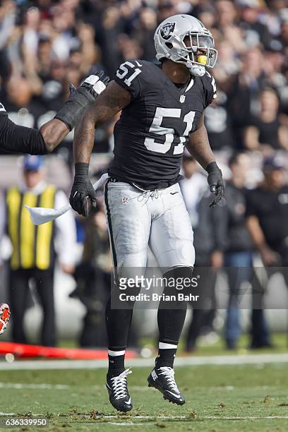 Outside linebacker Bruce Irvin of the Oakland Raiders celebrates after sacking quarterback Tyrod Taylor of the Buffalo Bills in the first quarter on...