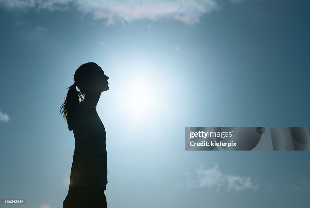Young woman looking up into the sky