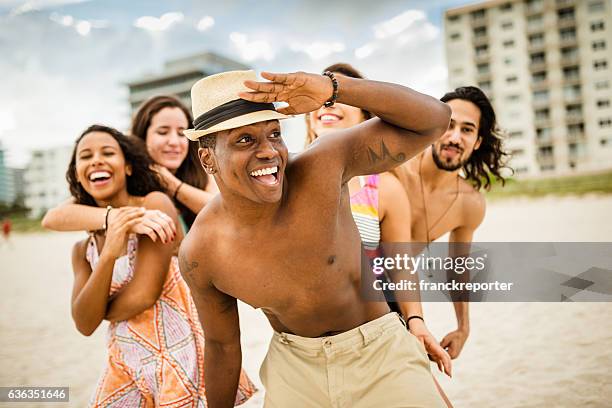 friends dancing on the beach for a party - spring break stock pictures, royalty-free photos & images