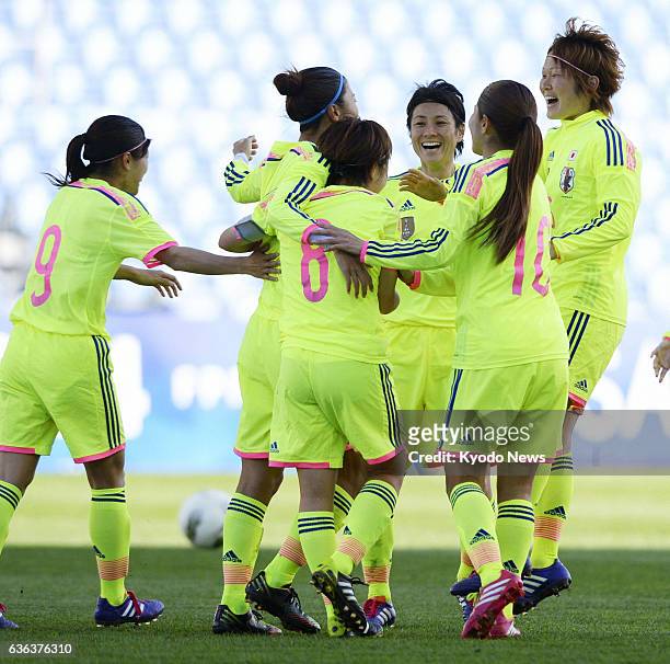Portugal - Japan striker Yuki Ogimi celebrates with her teammates after her game-tying goal against Sweden in Faro, Portugal, on March 10 in the...