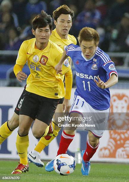 Japan - Japan's Yokohama M. Marinos striker Manabu Saito dribbles the ball during a Group G match pitting the AFC Champions League against China's...