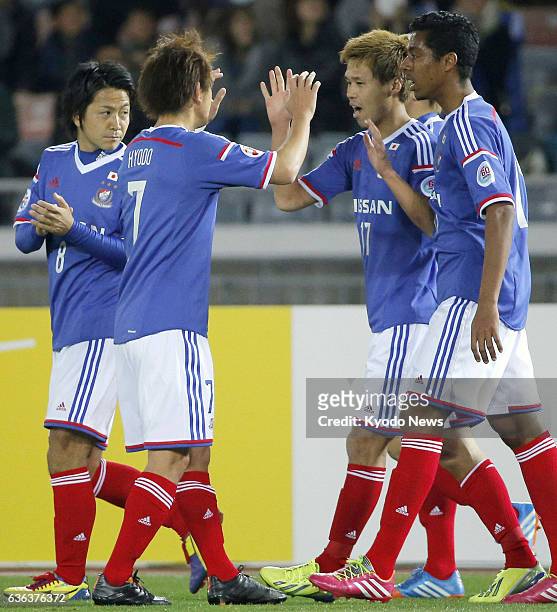 Japan - Yokohama M. Marinos striker Jin Hanato celebrates with his teammates after scoring the opening goal during their Group G match against...