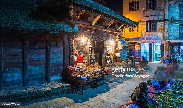 kathmandu warmly illuminated night market spice sellers durbar square nepal - kathmandu nepal stock pictures, royalty-free photos & images
