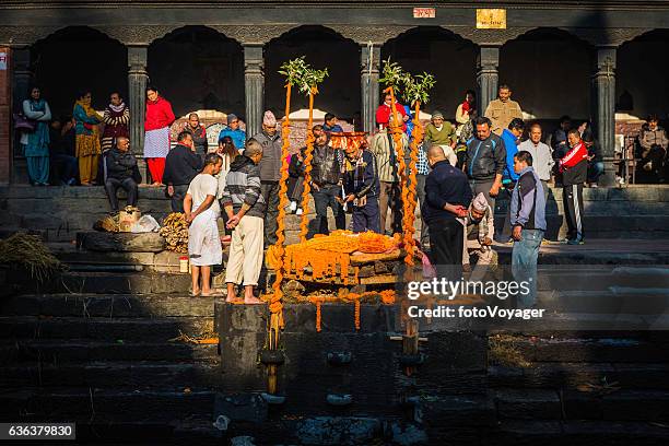 kathmandu mourners at funeral pyre ghat pashupatinath temple nepal - hinduism stock pictures, royalty-free photos & images