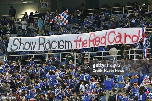 Japan - Supporters of Japanese J-League Division 1 club Yokohama F. Marinos put up an English banner reading "Show Racism the Red Card" during...