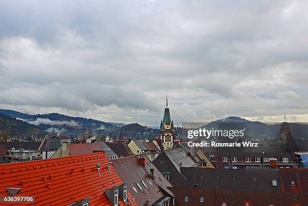 view over the roofs of freiburg with schwabentor city gate. - freiburg skyline stock pictures, royalty-free photos & images