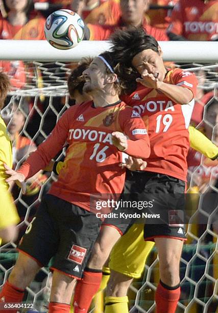 Japan - J-League footballers Joshua Kennedy and Kisho Yano of Nagoya Grampus go up to head the ball during the second half of a J1 game against...