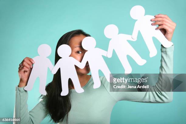 woman holding paper people - paper man stock pictures, royalty-free photos & images
