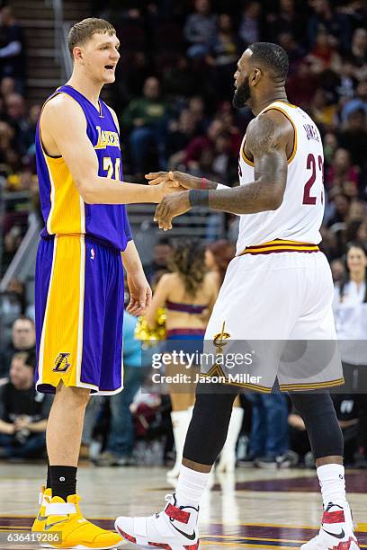 Timofey Mozgov of the Los Angeles Lakers and LeBron James of the Cleveland Cavaliers talk on the court between plays at Quicken Loans Arena on...