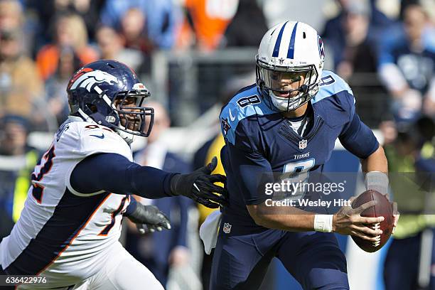 Marcus Mariota of the Tennessee Titans scrambles out of the grasp of Sylvester Williams of the Denver Broncos at Nissan Stadium on December 11, 2016...