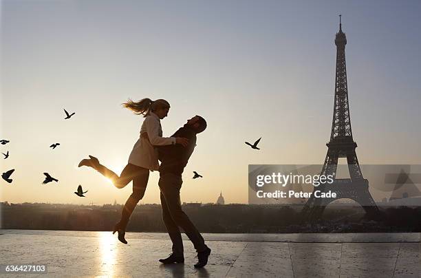couple embracing, view of eiffel tower - couple paris stockfoto's en -beelden