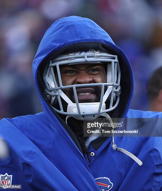 Brandon Spikes of the Buffalo Bills looks on from the sideline while wearing an overcoat during NFL game action against the Cleveland Browns at New...