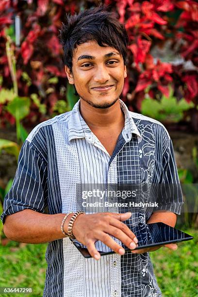 sri lankan teenager using a digital tablet - sri lankan ethnicity stock pictures, royalty-free photos & images