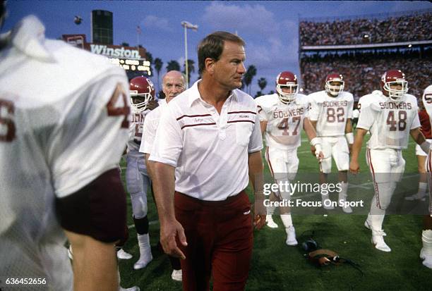 Heads coaches Barry Switzer of the University of Oklahoma walks off the field with his team after a NCAA football game circa 1986. Switzer was the...