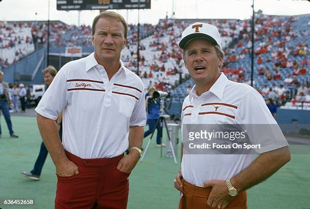 Heads coaches Barry Switzer of the University of Oklahoma and Fred Akers of the University of Texas looks on prior to there NCAA football game...
