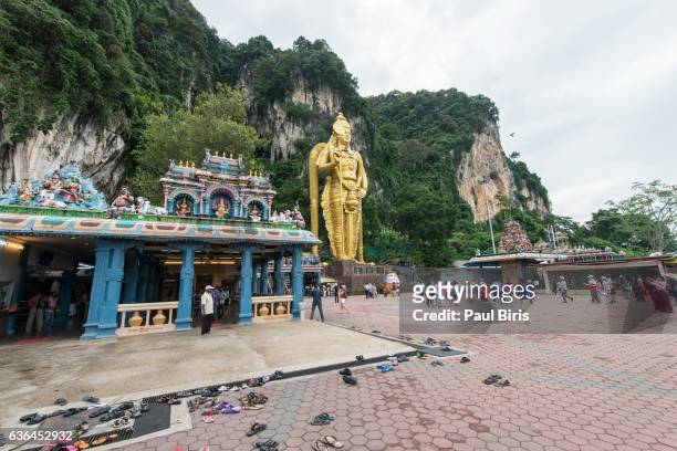 low angle view of lord murugan statue at batu caves - batu caves stock pictures, royalty-free photos & images