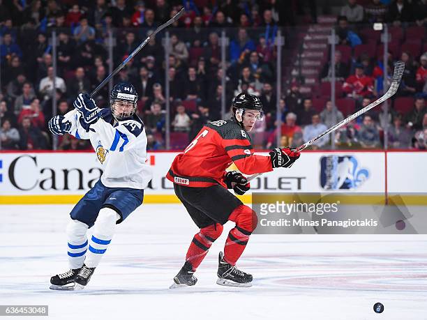 Kristian Vesalainen of Team Finland and Philippe Myers of Team Canada chase the puck during the IIHF exhibition game at the Bell Centre on December...