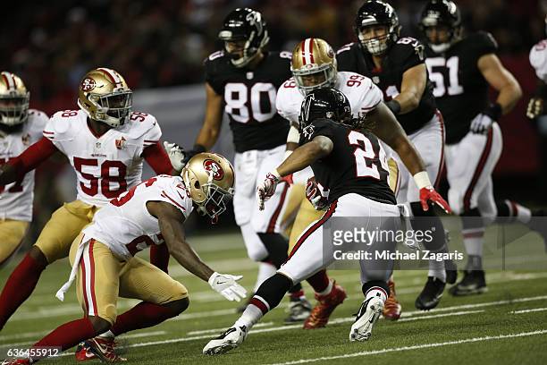 Tramaine Brock of the San Francisco 49ers tackles Devonta Freeman of the Atlanta Falcons during the game at the Georgia Dome on December 18, 2016 in...