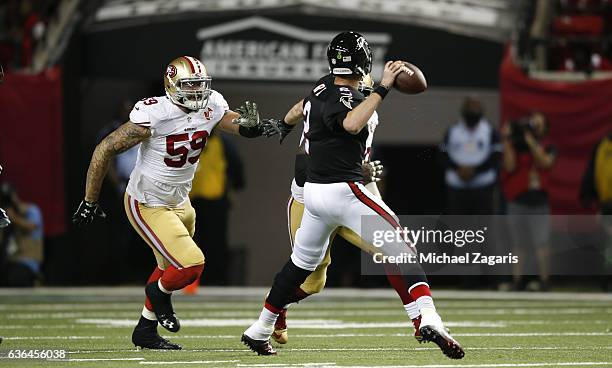 Aaron Lynch of the San Francisco 49ers closes in on Matt Ryan of the Atlanta Falcons during the game at the Georgia Dome on December 18, 2016 in...