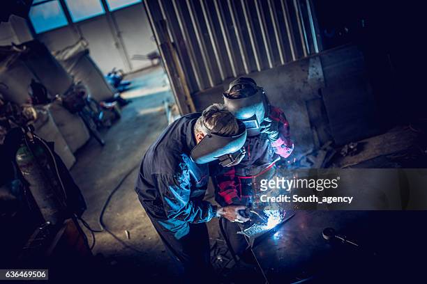 welder team in workshop - welder stock pictures, royalty-free photos & images