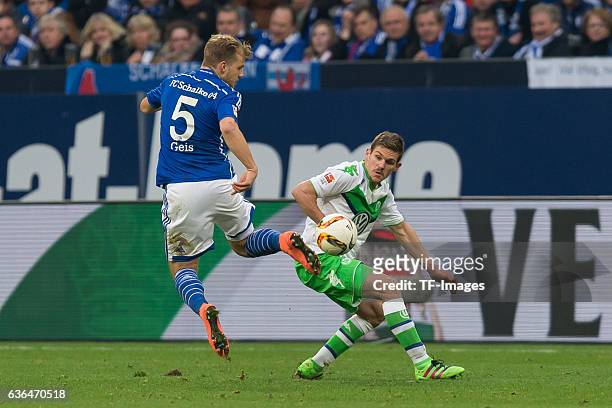 Johannes Geis of Schalke 04 and Sebastian JUNG of VfL Wolfsburg battle for the ball during the Bundesliga match between FC Schalke 04 and VfL...