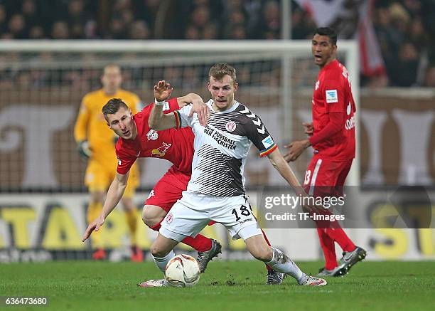 Willi Orban of RB Leipzig and Lennart Thy of St. Pauli battle for the ball during the Second Bundesliga match between FC St. Pauli and RasenBallsport...