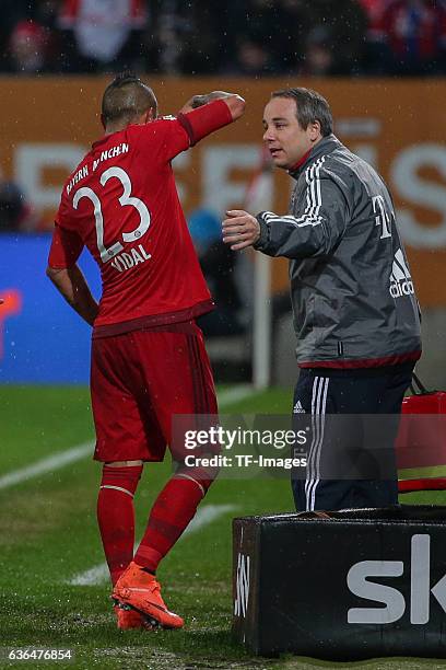 Doctor Dr. Volker Braun of Bayern Muenchen give instructions to Arturo Vidal of Bayern Muenchen during the Bundesliga match between FC Augsburg and...