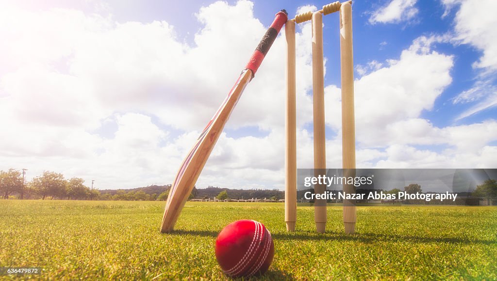 Cricket Bat Ball And Wickets In Cricket Ground High-Res Stock Photo