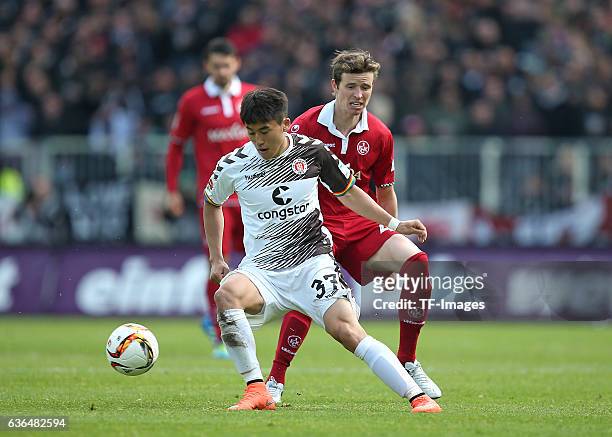 Kyoung-Rok Choi of FC St. Pauli and Patrick Ziegler of Kaiserslautern battle for the ball during the Second Bundesliga match between FC St. Pauli and...