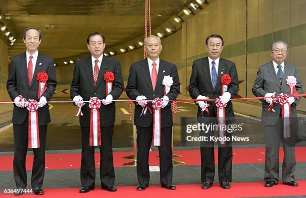 Japan - Transport minister Akihiro Ota and Tokyo Gov. Yoichi Masuzoe attend a tape-cutting ceremony to mark the opening of a newly built road between...