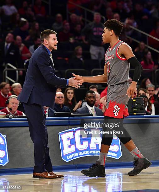 Malik Ellison meets with assistant coach Greg St. Jean of the St. JohnÕs Red Storm against the Penn State Nittany Lions at Madison Square Garden on...