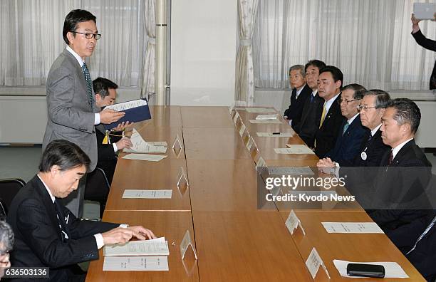 Japan - Environment Minister Nobuteru Ishihara , accompanied by Reconstruction Minister Takumi Nemoto , explains a new plan for the interim storage...