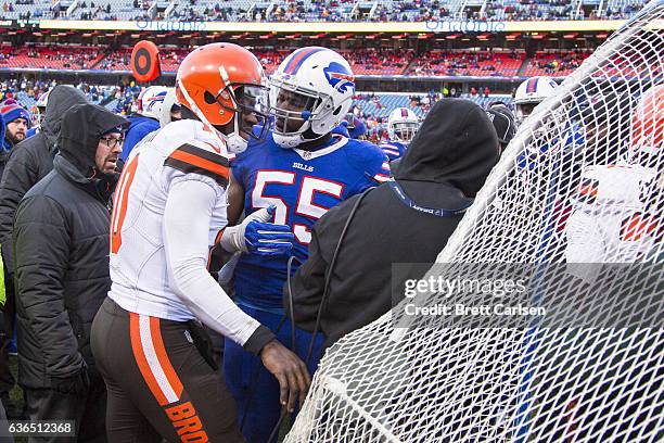 Jerry Hughes of the Buffalo Bills talks to Robert Griffin III of the Cleveland Browns after Griffin knocked over a member of the TV crew during the...