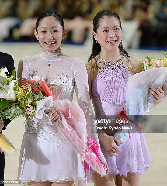 Japan - Japanese figure skaters Miki Ando and Akiko Suzuki hold bouquets after their retirement ceremony in Nagoya, central Japan, on April 3, 2014....