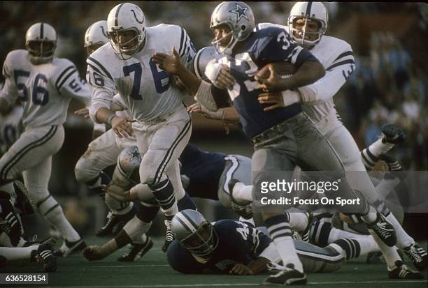Running back Duane Thomas of the Dallas Cowboys is wrapped up by linebacker Mike Curtis of the Baltimore Colts January 17, 1971 during Super Bowl V...